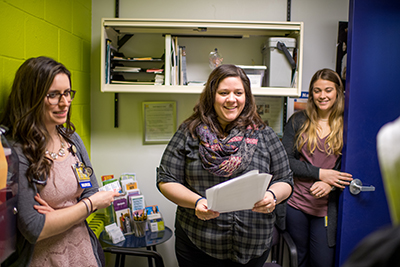 Kuzma at her RAHS clinic with UMSN alumna Elizabeth Shea and current student Sydney Liedel