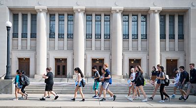 People walking past Hill Auditorium at The University of Michigan