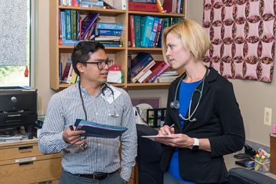 Gultekin consults with Jose Galianto, a UMSN alum who also cares for patients at Hope Clinic