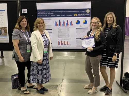 group of faculty members with poster award at conference