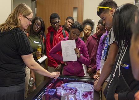 Students learning about the Anatomage table, one of the many high-tech learning tools in UMSN's CLC