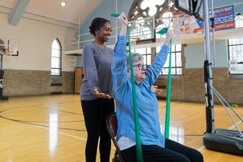 Research Associate She'Lon Tucker helps a participant with one of the activities